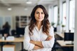 © Viewvie - Happy casual businesswoman looking at camera with crossed arms in office, New generation of energetic entrepreneurs concept.