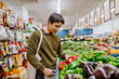 © Austockphoto - Man buying fresh produce at supermarket