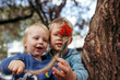 © Austockphoto - Two young boys in a tree together playing