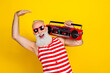 Photo of feeling young funny in swimsuit grandfather dance with retro boombox summer discotheque party isolated on yellow color background
