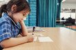 © Austockphoto - Young student girl writing in libary