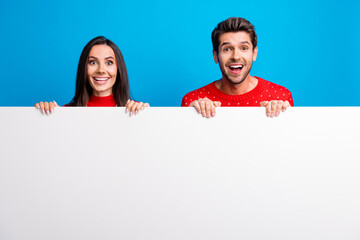 Sticker - Photo portrait of pretty young lovers excited hide white wall dressed x-mas ornament red sweaters isolated on blue color background