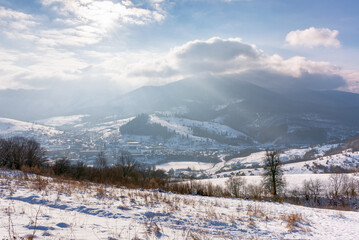 Wall Mural - mountainous carpathian countryside in winter. rolling landscape with snow covered hills. misty weather with clouds above the ridge