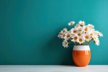 Daisy Flowers Bouquet In Orange Vase On White Wooden Coffee Table Near Turquoise Wall Background. Interior Design Of Modern Living Room With Space For Text.