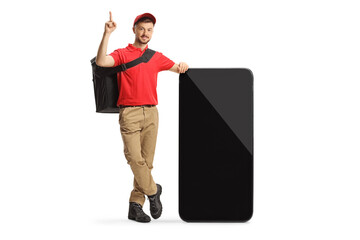 Wall Mural - Food delivery guy leaning on a smartphone and pointing up