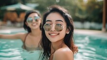 Young Beautiful Asian Woman Friends Are Swimming And Joking In The Pool