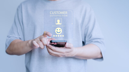 Fototapete - Customer using a smartphone give smile face icon for feedback review satisfaction service opinion and testimonial