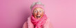 Excited eccentric elderly granny wearing knit sweater winter clothes and headband, pink background, surprised expression
