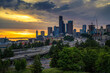 Dramatic sunset over the Seattle downtown skyline, with traffic on the I-5 and I-90 freeway interchange, viewed from Dr. Jose Rizal Bridge.