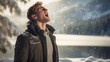 Handsome young male singer singing outdoors in the falling snow during the winter holiday season