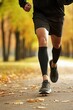© Stavros - Jogging workout in autumn forest. Legs of a man close up. Man during jogging workout in an autumn city park. Keeping fit in any age.