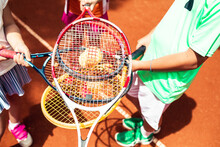 Close-up Of Tennis Players Holding Rackets On A Clay Court