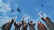 © Довидович Михаил - Joyful graduates stand in a row and toss their caps up in the air.