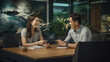 © javier - Satisfied customers finalizing a contract with a service provider in a comfortable office setting.