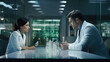 © javier - A scientist meeting with a lab technician to collaborate on a research project.