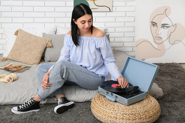 Wall Mural - Young woman with record player in bedroom