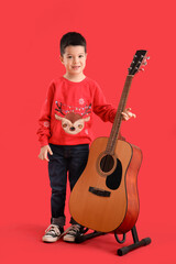 Sticker - Cute little Asian boy with guitar on red background