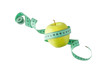 Green apple and measuring tape flying isolated on white background. Symbol of healthy dieting and control weight.