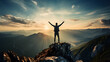 A man standing on top of a mountain celebrating with arms open. Success and goal achievement concept