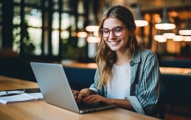 Young student woman studying with laptop in the school library, learning online