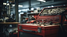 A Selective Focus Of Mechanic's Toolbox With Tools In Drawers, Blurred Background, Auto Mechanic In Workshop.