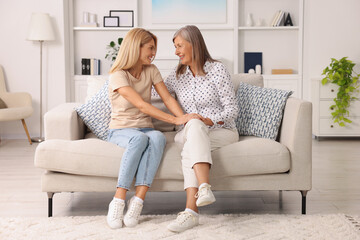 Wall Mural - Happy mature mother and her daughter spending time together at home