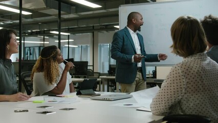 Wall Mural - Multiracial group of coworkers in businesswear talking and gesturing next to whiteboard in office