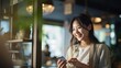 © Phoophinyo - A Portrait of A female Asian Woman handing her credit card to make a payment in a cafe.