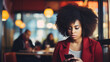 African American woman with serious and worried attitude while looking and texting on her cell phone, sitting in a bar. copy space.