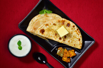 Wall Mural - Sliced paratha with aachar and dahi top view