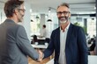 © radekcho - Smiling middle aged business man handshaking partner, making partnership collaboration agreement at office meeting. HR manager and new worker shake hands recruiting at job interview.