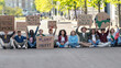 © Lomb - Environmental activists protesting for change - A group of activists gather in an urban setting, holding signs that call for action against climate change. Their placards bear powerful messages.