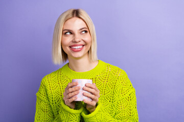 Sticker - Photo of excited dreamy woman dressed knitted sweater drinking cacao looking empty space isolated violet color background