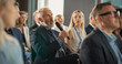 © Gorodenkoff - Senior Male Investor Sitting In Crowd And Using Microphone To Ask A Question At International Technology Conference. Caucasian Man Listening To Keynote Presentation About New Startup Company Service.