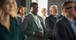 © Gorodenkoff - Black Man Sitting in a Crowded Audience at Business Conference. Corporate Delegate Using Laptop Computer While Listening to an Inspirational Entrepreneurship Presentation About Developing Markets.