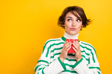 Sticker - Photo of thoughtful pretty girl dressed striped sweater drinking tea looking empty space isolated yellow color background