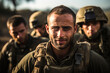 A portrait of an Israeli soldier ready for battle in combat gear against the background of other soldiers