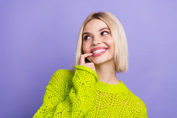 Poster - Photo of adorable tricky lady wear green pullover finger mouth looking empty space isolated purple color background