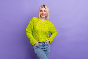 Sticker - Photo of pretty adorable lady wear green pullover smiling hands arms pockets isolated purple color background