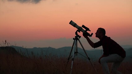 Wall Mural - astronomer looking at the sky with a telescope.