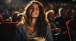 Young woman watching movie in cinema. Girl eating popcorn and smiling.