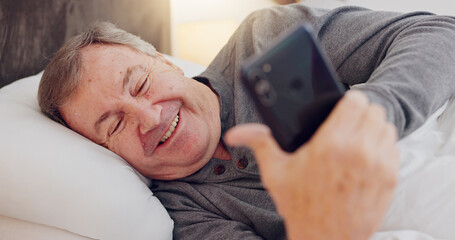 Poster - Senior man, happy and reading with phone in bed or streaming funny, comedy or meme on social media. Elderly person, smile or relax with cellphone at night in bedroom with communication or online chat