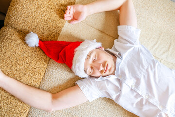 Wall Mural - Young Man sleep in Santa Hat