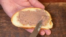 Spreading Liver Pate On Bread In Kitchen
