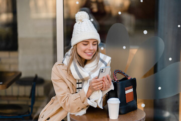 Wall Mural - stylish woman walking in winter street