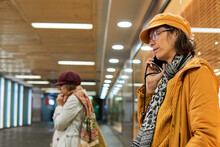 Mid Adult Females Making A Call With Smartphone On The Underground Station