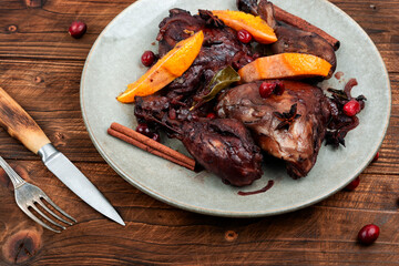 Wall Mural - Baked chicken legs with orange and berries.