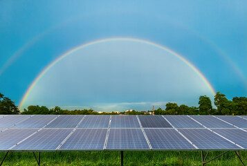 Wall Mural - Photovoltaic solar power panel with a double rainbow blue sky, Alternative energy concept,Clean energy,Green energy.