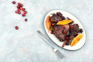 Canvas Print - Barbecue chicken legs with orange and berries.