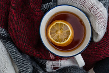 Overhead View Of A Cup Of Hot Black Tea With Lemon Wrapped In A Scarf